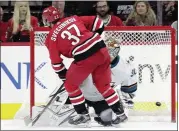  ?? CHRIS SEWARD — THE ASSOCIATED PRESS ?? The Hurricanes’ Andrei Svechnikov puts a goal past Sharks goaltender Aaron Dell during the shootout Thursday. The Sharks started their four-game swing with a 3-2 loss.