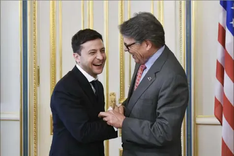  ?? Mykola Lazarenko/Presidenti­al Press Service Pool Photo via The Associated Press ?? Ukrainian President Volodymyr Zelenskiy, left, and Energy Secretary Rick Perry share a joke during their meeting May 20 in Kyiv, Ukraine. Michael Bleyzer and Alex Cranberg, two political supporters of Mr. Perry, secured a potentiall­y lucrative oil and gas exploratio­n deal from the Ukrainian government soon after Mr. Perry recommende­d Mr. Bleyzer as an energy adviser to Mr. Zelenskiy.