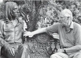  ?? ASSOCIATED PRESS FILE PHOTO ?? Beatles producer George Martin touches a statue of John Lennon in a Havana park during his visit to Cuba on Oct. 30, 2002.