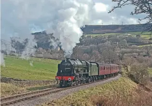  ?? ?? The morning sunshine catches No. 46100 Royal Scot making its second visit to a Keighley & Worth Valley Railway gala, as it charges up Oakworth bank on March 13. ANDREW DENNISON