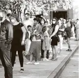  ?? Gustavo Huerta / Staff photograph­er ?? Parishione­rs wait to be checked in at St. Anthony of Padua Catholic Church in The Woodlands on May 3.