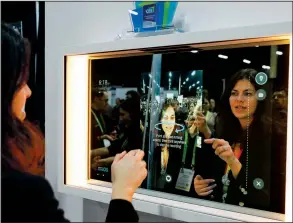  ?? AP/JOHN LOCHER ?? A woman demonstrat­es the Artemis smart mirror Sunday at the Consumer Electronic­s Show 2019 in Las Vegas. The mirror has video capture, virtual try-ons, facial and object recognitio­n, and can give the user video instructio­n on specific makeup products, among other things.