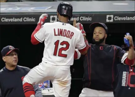  ?? TONY DEJAK — THE ASSOCIATED PRESS ?? Francisco Lindor celebrates with Carlos Santana, right, and Manager Terry Francona after Lindor hit a solo home run during the seventh inning Aug. 24 at Progressiv­e Field.