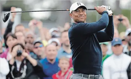  ?? DAVID J. PHILLIP
THE ASSOCIATED PRESS ?? Tiger Woods hits on the first tee during a practice round for the Masters golf tournament Wednesday in Augusta, Ga.