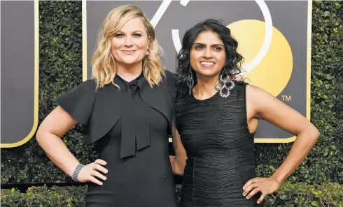  ?? Kevork Djansezian / NBC / NBCU Photo Bank via Getty Images ?? Saru Jayaraman, a restaurant-industry activist (right), stands with Amy Poehler at the Golden Globes in support of the #MeToo movement.