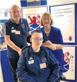  ??  ?? New fan Linda Fabiani MSP meets with East Kilbride Powerchair football star Thomas Pettigrew and his dad Willie at the Scottish Parliament