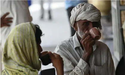  ?? Photograph: Aamir Qureshi/AFP/Getty Images ?? People enjoy a cup of tea at a roadside restaurant in Islamabad.