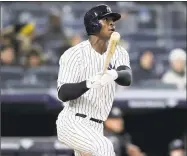  ?? Elsa / Getty Images ?? The Yankees’ Didi Gregorius hits a two-run home run in the fourth inning of Monday’s 12-1 win over the Marlins in New York.