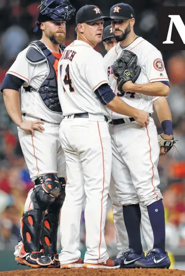  ?? Karen Warren / Houston Chronicle ?? Astros manager A.J. Hinch (14) has been to the mound often lately, with Mike Fiers, right, the only starter in the last 14 games to make it through six innings.