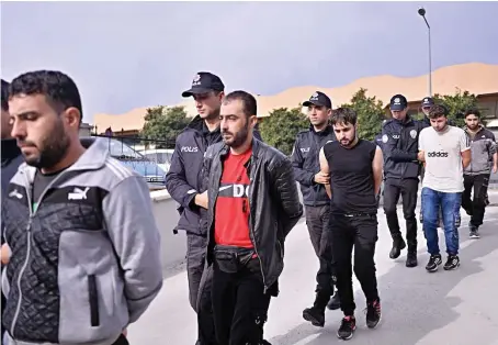  ?? AFP/File ?? Suspected Daesh-linked men being taken into custody after they were captured in an operation carried out by Turkish security, in Mersin.