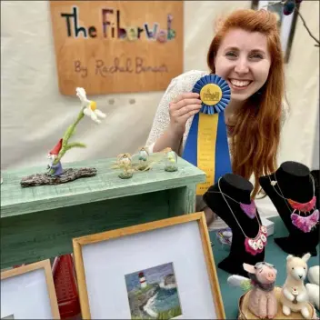  ?? COURTESY RACHEL BENSON ?? Rachel Benson poses with her award-winning felted 2D and 3D art at a 2021event in Saco, Maine.