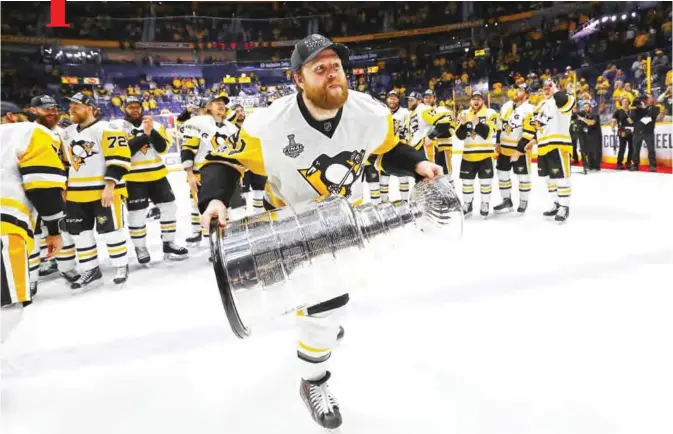  ??  ?? NASHVILLE: Phil Kessel #81 of the Pittsburgh Penguins celebrates with the Stanley Cup Trophy after they defeated the Nashville Predators 2-0 in Game Six of the 2017 NHL Stanley Cup Final at the Bridgeston­e Arena on Sunday in Nashville, Tennessee. — AFP