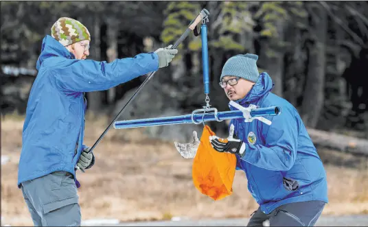  ?? California Department of Water Resources ?? California water supply forecastin­g official Sean de Guzman, right, and engineer Anthony Burdock weigh the aluminum snow depth survey pole in order to measure the water content during the first snow survey of the year Tuesday in Phillips Station, Calif.