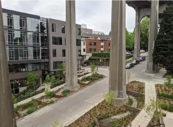  ?? Mark Dorsey/weber Thompson via The New York Times ?? The Watershed building, next to the Aurora Bridge in Seattle. Bioswales outside the building filter polluted water coming off the bridge before it reaches a nearby lake.