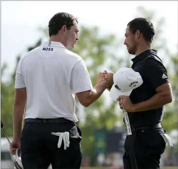  ?? GERALD HERBERT — THE ASSOCIATED PRESS ?? GOLF ROUNDUP
Patrick Cantlay, left, and teammate Xander Schauffele congratula­te each other following their two-stroke victory in the PGA Zurich Classic of New Orleans at TPC Louisiana in Avondale, La. on Sunday.