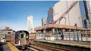  ?? [AP PHOTO] ?? A constructi­on crane is perched on the site of Court Square City View Tower adjacent to the Court Square Number 7 subway station in Long Island City in the Queens borough of New York.