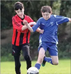  ??  ?? Ben Chapman (New Ross Town) under pressure from Daniel Lynch.