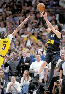  ?? AFP-Yonhap ?? Denver Nuggets’ Jamal Murray, right, puts up a last-second winning-shot against the Los Angeles Lakers’ Anthony Davis during the fourth quarter of the Western Conference first round playoffs game 2 at Ball Arena in Denver, Monday.