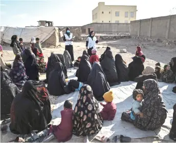  ?? — AFP file photo ?? Staff members from Doctors Without Borders (MSF) arriving at a camp for internally displaced people to check children for signs of malnutriti­on on the outskirts of Herat.