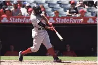  ?? Victor Decolongon / Getty Images ?? The Red Sox’s Xander Bogaerts hits a home run against the Angels in 2019.