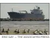  ?? ERIC GAY — THE ASSOCIATED PRESS ?? An oil tanker passes through a channel in Port Aransas, Texas.