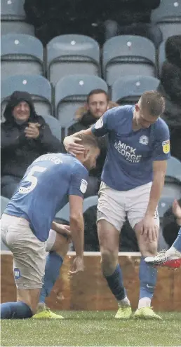  ??  ?? Posh players celebrate Mo Eisa’s 95th-minute equaliser