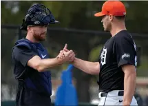  ?? CHARLIE NEIBERGALL — THE ASSOCIATED PRESS ?? Detroit Tigers catcher Carson Kelly, left, greets starting pitcher Matt Manning during a spring training workout Friday in Lakeland, Fla.