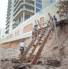  ?? J. PAT CARTER, AP ?? Constructi­on workers on Singer Island, Fla., rebuild a walk to the beach Nov. 29, 2012, after Superstorm Sandy.