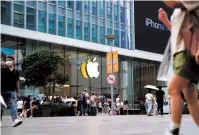  ?? Reuters-Yonhap ?? People walk past an Apple store in Shanghai, Sept. 13.