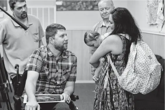  ?? Photos by Lisa Krantz / Staff photograph­er ?? Kris Workman, center, was paralyzed by a shot fired by Danielle Kelley’s husband, Devin, during the Sutherland Springs shooting and may never walk again.