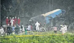  ??  ?? SEARCH FOR SURVIVORS: Rescue teams search through the wreckage of the Boeing 737 that plummeted into a field shortly after takeoff with 110 passengers on board in Havana.