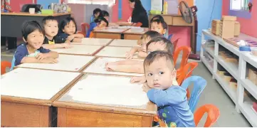  ??  ?? Shy children at the church’s learning centre.