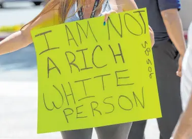  ?? Las Vegas Review-journal file ?? People hold signs as they call for education savings accounts during a rally in 2017 outside of the Sawyer Building in Las Vegas.