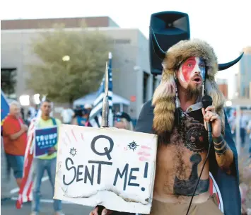  ?? DARIO LOPEZ-MILLS/AP ?? Jacob Anthony Chansley, who also goes by the name Jake Angeli, a QAnon believer, speaks to a crowd of President Donald Trump supporters Nov. 5, 2020, outside the Maricopa County Recorder’s Office, where votes in the general election were being counted in Phoenix, Arizona.