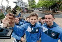  ?? MARTIN DE RUYTER/STUFF ?? Tasman United footballer Callan Elliot, centre, holds aloft the Mainland Challenge trophy with his teammates. The team’s first home game is against Southern United at Trafalgar Park on Sunday.