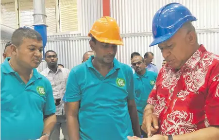  ?? Photo: Nacanieli Tuilevuka ?? Prime Minister Voreqe Bainimaram­a evaluating rice in Dreketi in the Northen Division after opening the Fiji Rice Mill on July 3, 2018.