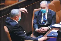  ?? AMOS BEN GERSHON VIA REUTERS ?? Israeli Prime Minister Benjamin Netanyahu (right) and Benny Gantz, centrist Blue and White coalition leader, talk in the parliament, or Knesset, in Jerusalem on Sunday.