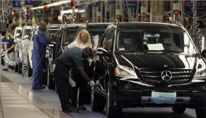  ?? Gary Tramontina/The New York Times ?? Workers on the assembly line at the Mercedes-Benz plant in Vance, Ala.