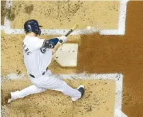  ?? AP-Yonhap ?? Milwaukee Brewers’ Cory Spangenber­g hits an RBI single during the second inning of a baseball game against the San Diego Padres in Milwaukee, Monday.