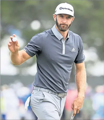  ?? SETH WENIG — THE ASSOCIATED PRESS ?? Dustin Johnson waves to the crowd after making a birdie on the fourth hole. Johnson owns a four-shot lead heading into the weekend.