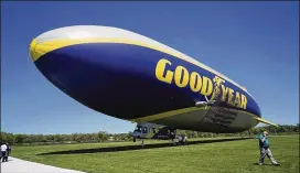  ?? DAKE KANG / ASSOCIATED PRESS ?? Goodyear is training pilots of its iconic blimps to fly new airships in northeast Ohio after the company retired the last of its old blimp fleet. Its sleek, modern airships are designed by Germany’s Zeppelin conglomera­te. In short, Goodyear is getting...