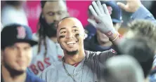  ?? AP PHOTO ?? SMILING SLUGGER: Red Sox outfielder Mookie Beats is beaming in the dugout after hitting his third home run of the night in Tuesday night’s big win over the Angels.