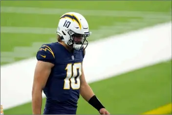  ?? AP PHOTO/ASHLEY LANDIS ?? Los Angeles Chargers quarterbac­k Justin Herbert reacts after the Chargers’ loss to the Las Vegas Raiders in an NFL football game Sunday in Inglewood, Calif.