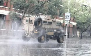  ?? | DOCTOR NGCOBO
African News Agency (ANA) ?? MISSION
POSSIBLE
AN SANDF vehicle drives through a road in rainy weather in Durban yesterday. The conditions are expected to ease up today with the South African Weather Service forecastin­g a 30% chance of rain this morning, becoming cloudy.