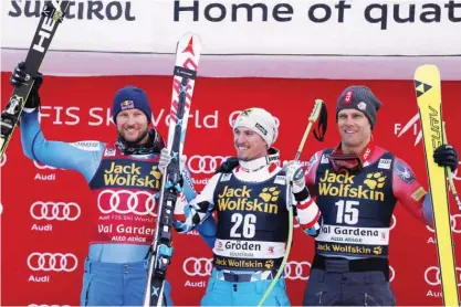  ?? — AP ?? VAL GARDENA: From left, second placed Aksel Lund Svindal, of Norway, first placed Max Franz of Austria and third placed Steven Nyman of the United States celebrate on the podium of an alpine ski, men’s World Cup downhill, in Val Gardena, Italy, yesterday.