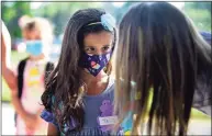  ?? Erik Trautmann / Hearst Connecticu­t Media ?? Kindergart­ner Valentia Kinsey says goodbye to her mother as students arrive for their first day of class at Long Hill Elementary School Wednesday in Shelton.