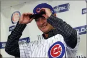  ?? CARLOS OSORIO - THE ASSOCIATED PRESS ?? Chicago Cubs starting pitcher Yu Darvish tries on the team’s cap during a media availabili­ty at the team’s spring training baseball facility Tuesday, Feb. 13, 2018, in Mesa, Ariz. Darvish signed a $126million, six-year contract over the weekend.