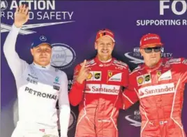  ?? AFP ?? Ferrari's Sebastian Vettel (C), Kimi Raikkonen (R) and Mercedes' Valtteri Bottas pose after the qualifying sessions on Saturday.