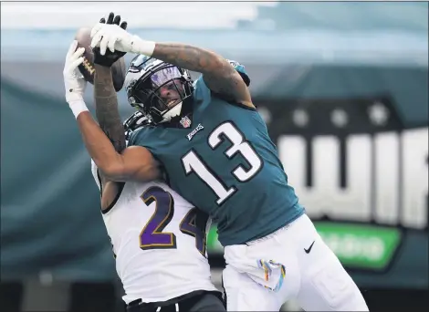  ?? CHRIS SZAGOLA — THE ASSOCIATED PRESS ?? Philadelph­ia Eagles’ Travis Fulgham, right, cannot catch a pass against Baltimore Ravens’ Marcus Peters during Sunday’s game.