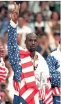  ??  ?? Michael Jordan used an American flag to hide the Reebok logo on his jacket during the medal ceremony at the 1992 Olympics.